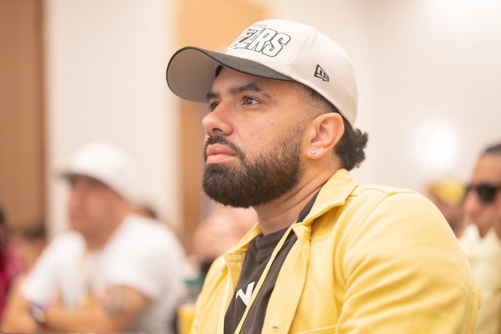 An attendee listening closely during a conference session