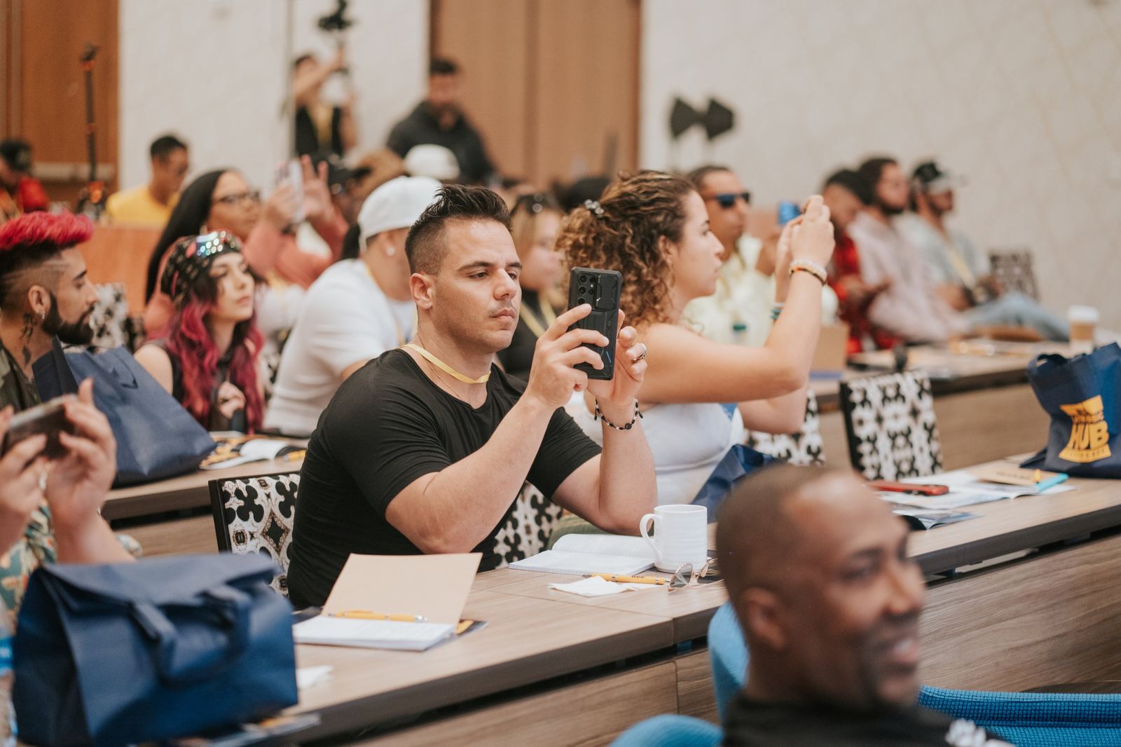 Members of the Latin music community attending a conference session