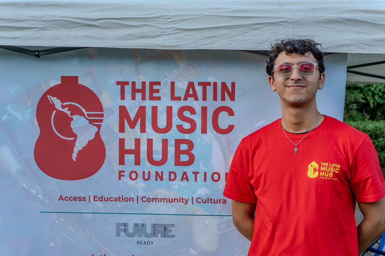 A volunteer at The Latin Music Hub Foundation booth