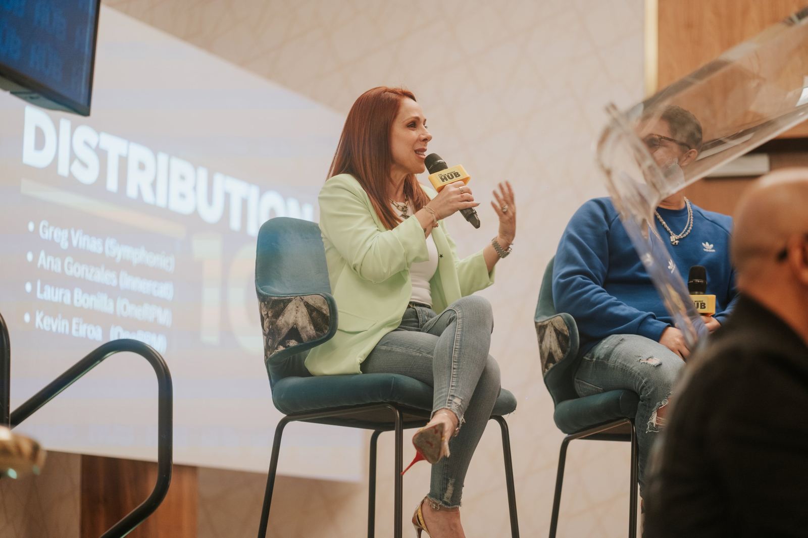 A panelist explaining music distribution on stage