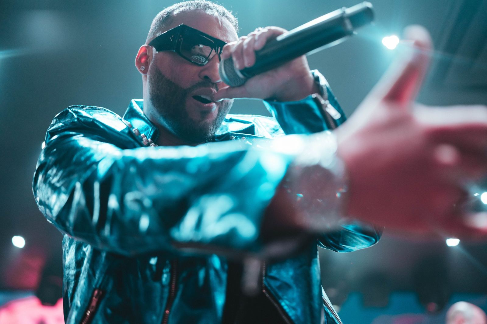 A performer reaching toward the audience mid-song
